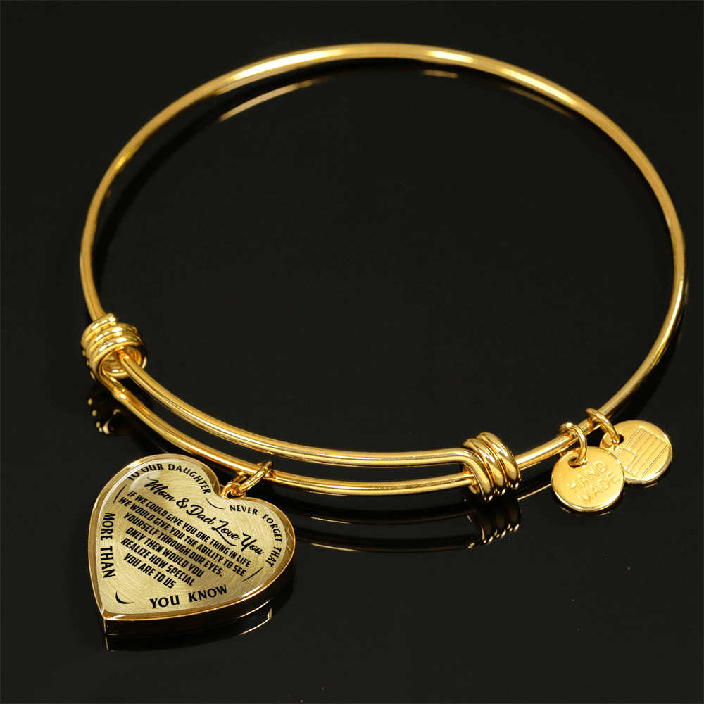 TO OUR DAUGHTER, MOM & DAD LOVE YOU, NEVER FORGET THAT - GOLD AND SILVER FINISHED HEART SHAPED BANGLE BRACELET (BLACK TEXT ON TRANSPARENT)