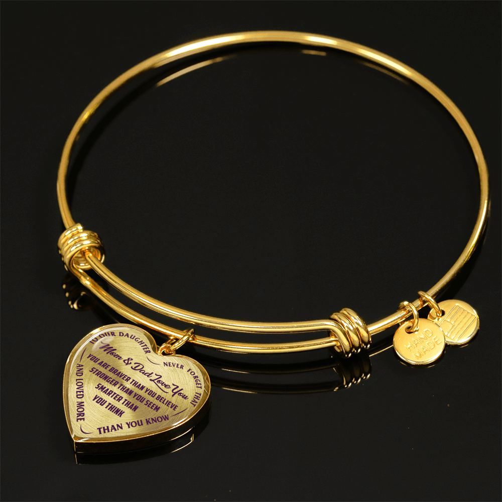 TO OUR DAUGHTER, YOU ARE BRAVER, MOM & DAD LOVE YOU - GOLD AND SILVER FINISHED HEART SHAPED BANGLE BRACELET (PURPLE TEXT ON TRANSPARENT)