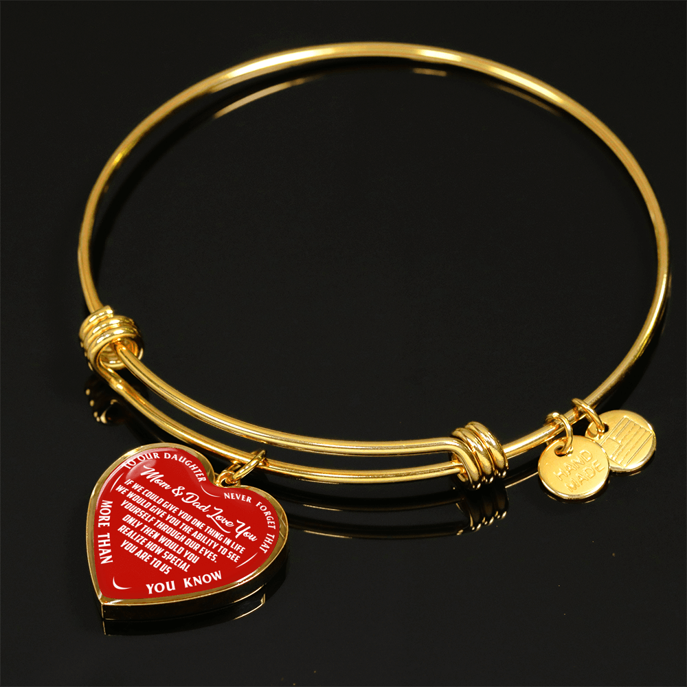 TO OUR DAUGHTER, MOM & DAD LOVE YOU, NEVER FORGET THAT - GOLD AND SILVER FINISHED HEART SHAPED BANGLE BRACELET (WHITE TEXT ON RED)
