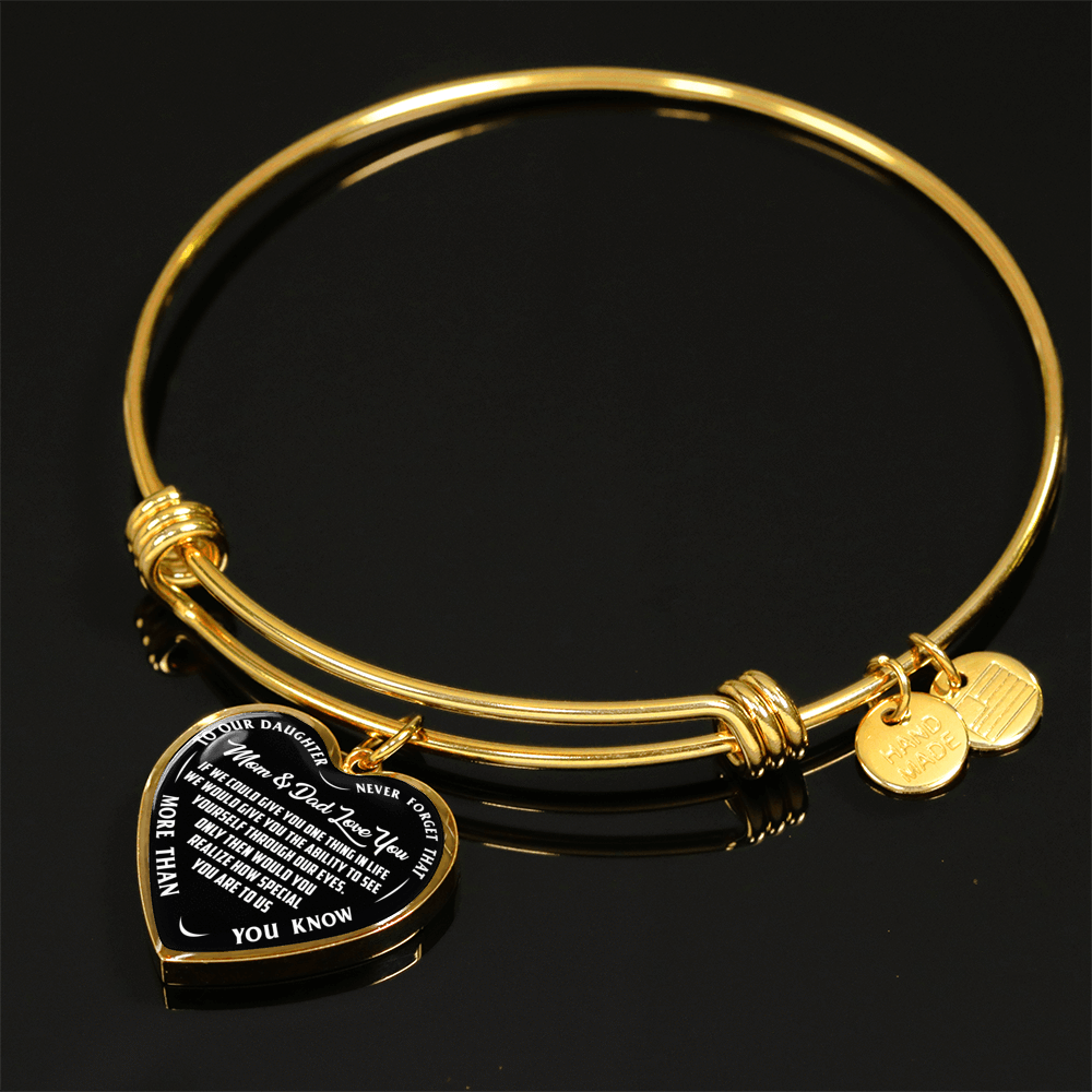 TO OUR DAUGHTER, MOM & DAD LOVE YOU, NEVER FORGET THAT - GOLD AND SILVER FINISHED HEART SHAPED BANGLE BRACELET (WHITE TEXT ON BLACK)