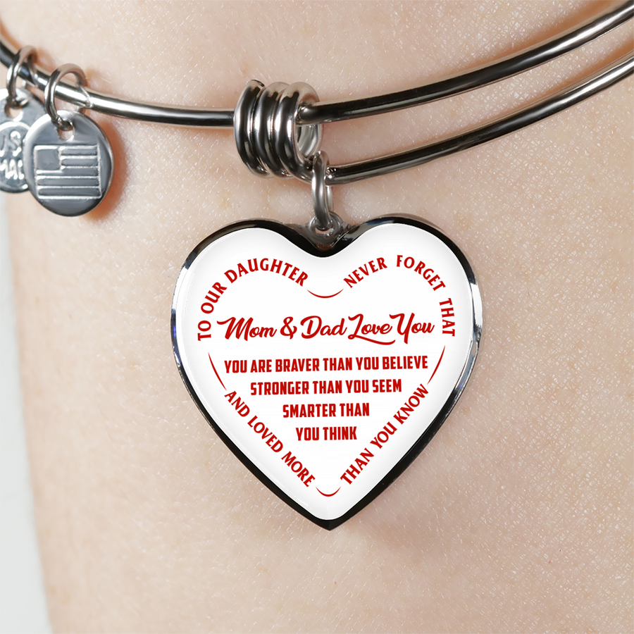 TO OUR DAUGHTER, YOU ARE BRAVER, MOM & DAD LOVE YOU - GOLD AND SILVER FINISHED HEART SHAPED BANGLE BRACELET (RED TEXT ON WHITE)
