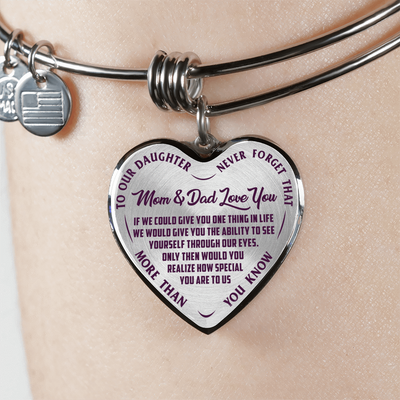 TO OUR DAUGHTER, MOM & DAD LOVE YOU, NEVER FORGET THAT - GOLD AND SILVER FINISHED HEART SHAPED BANGLE BRACELET (PURPLE TEXT ON TRANSPARENT)