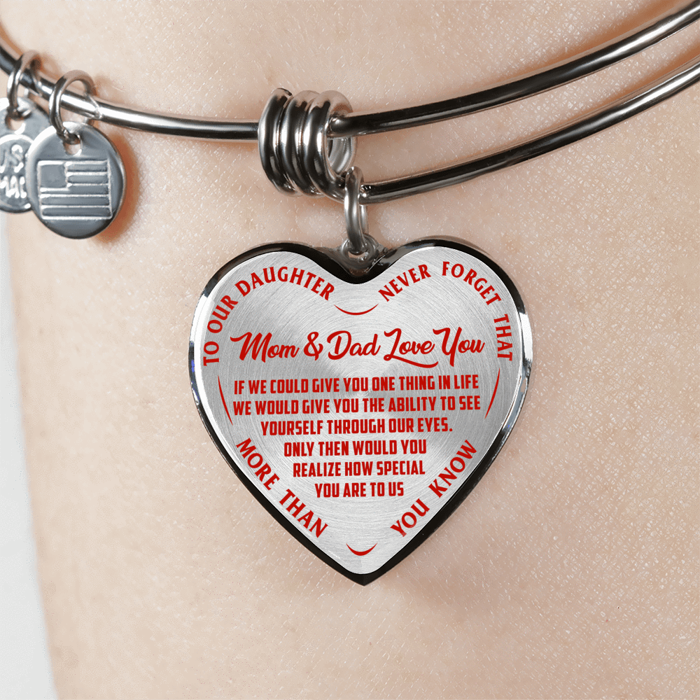 TO OUR DAUGHTER, MOM & DAD LOVE YOU, NEVER FORGET THAT - GOLD AND SILVER FINISHED HEART SHAPED BANGLE BRACELET (RED TEXT ON TRANSPARENT)