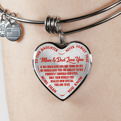 TO OUR DAUGHTER, MOM & DAD LOVE YOU, NEVER FORGET THAT - GOLD AND SILVER FINISHED HEART SHAPED BANGLE BRACELET (RED TEXT ON TRANSPARENT)
