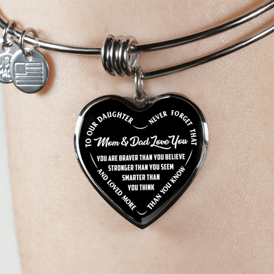 TO OUR DAUGHTER, YOU ARE BRAVER, MOM & DAD LOVE YOU - GOLD AND SILVER FINISHED HEART SHAPED BANGLE BRACELET (WHITE TEXT ON BLACK)