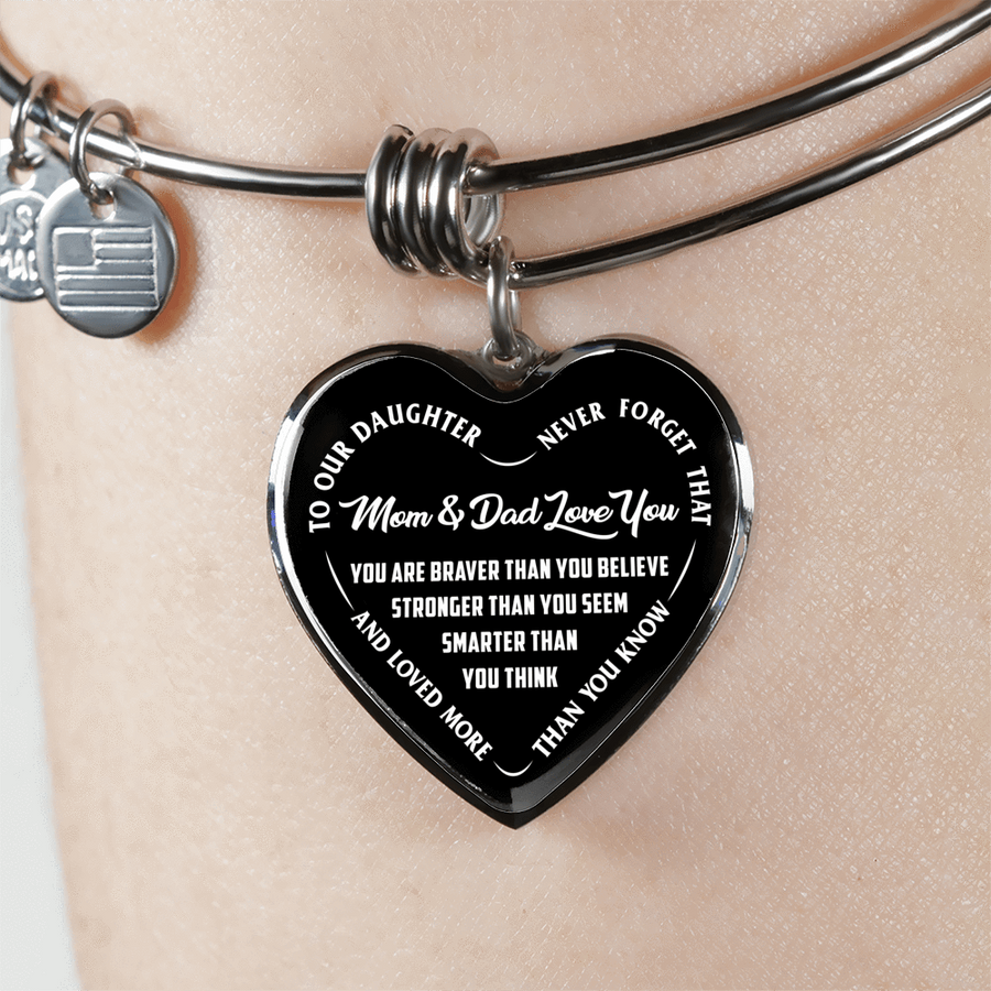 TO OUR DAUGHTER, YOU ARE BRAVER, MOM & DAD LOVE YOU - GOLD AND SILVER FINISHED HEART SHAPED BANGLE BRACELET (WHITE TEXT ON BLACK)