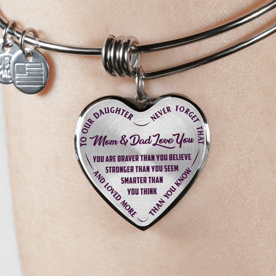 TO OUR DAUGHTER, YOU ARE BRAVER, MOM & DAD LOVE YOU - GOLD AND SILVER FINISHED HEART SHAPED BANGLE BRACELET (PURPLE TEXT ON TRANSPARENT)