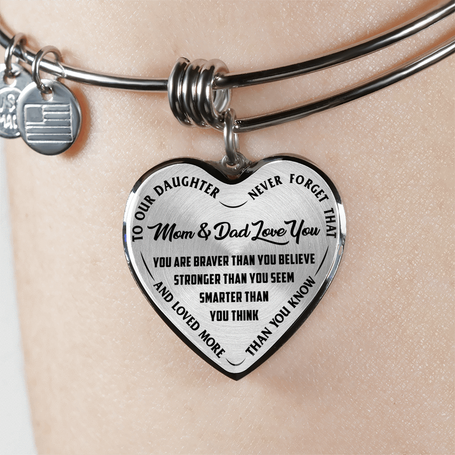 TO OUR DAUGHTER, YOU ARE BRAVER, MOM & DAD LOVE YOU - GOLD AND SILVER FINISHED HEART SHAPED BANGLE BRACELET (BLACK TEXT ON TRANSPARENT)