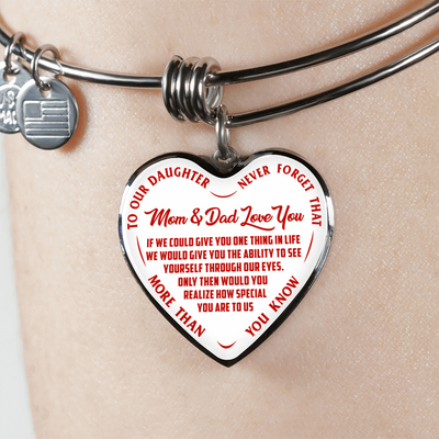 TO OUR DAUGHTER, MOM & DAD LOVE YOU, NEVER FORGET THAT - GOLD AND SILVER FINISHED HEART SHAPED BANGLE BRACELET (RED TEXT ON WHITE)
