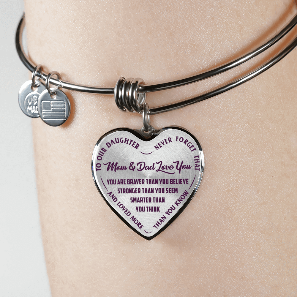 TO OUR DAUGHTER, YOU ARE BRAVER, MOM & DAD LOVE YOU - GOLD AND SILVER FINISHED HEART SHAPED BANGLE BRACELET (PURPLE TEXT ON TRANSPARENT)