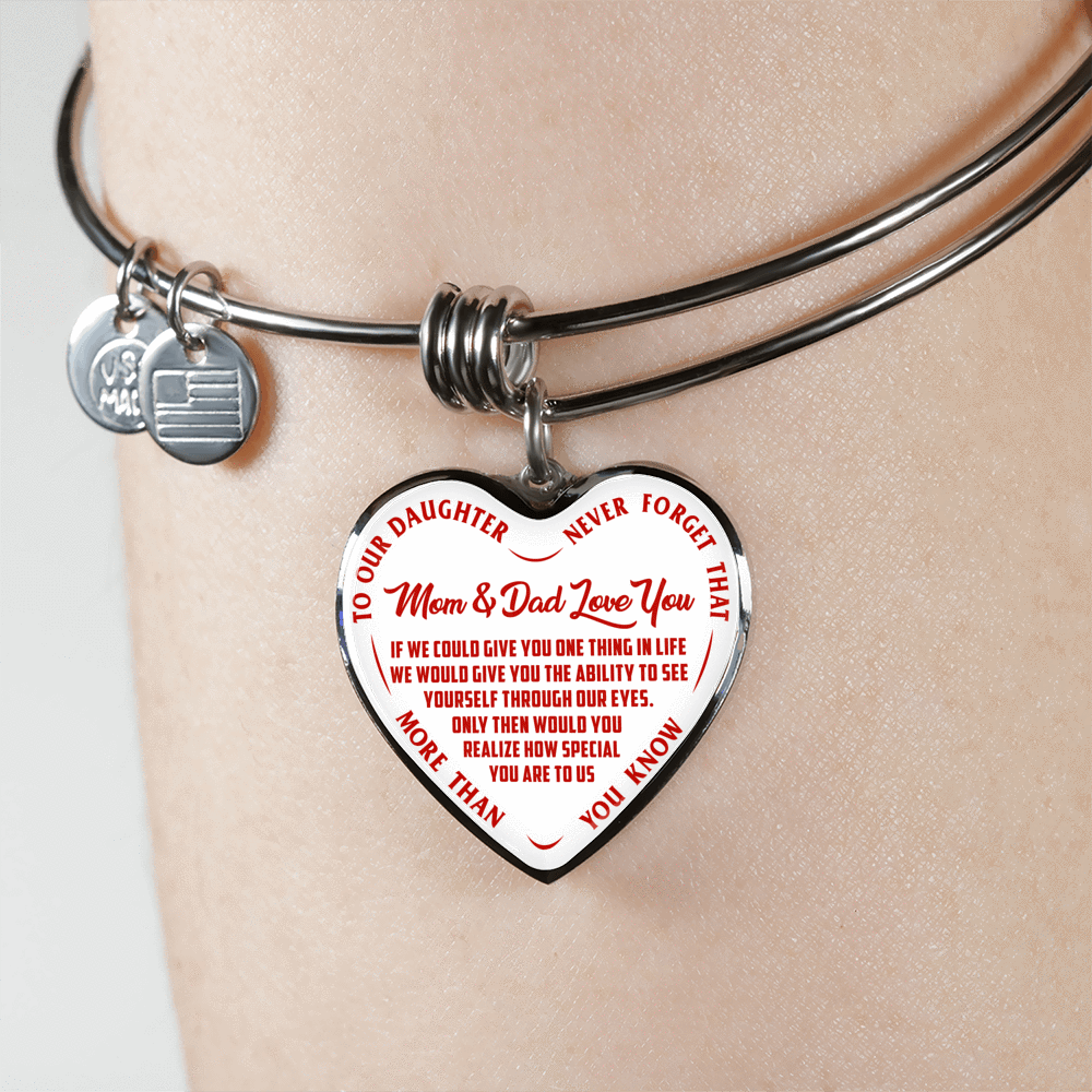 TO OUR DAUGHTER, MOM & DAD LOVE YOU, NEVER FORGET THAT - GOLD AND SILVER FINISHED HEART SHAPED BANGLE BRACELET (RED TEXT ON WHITE)