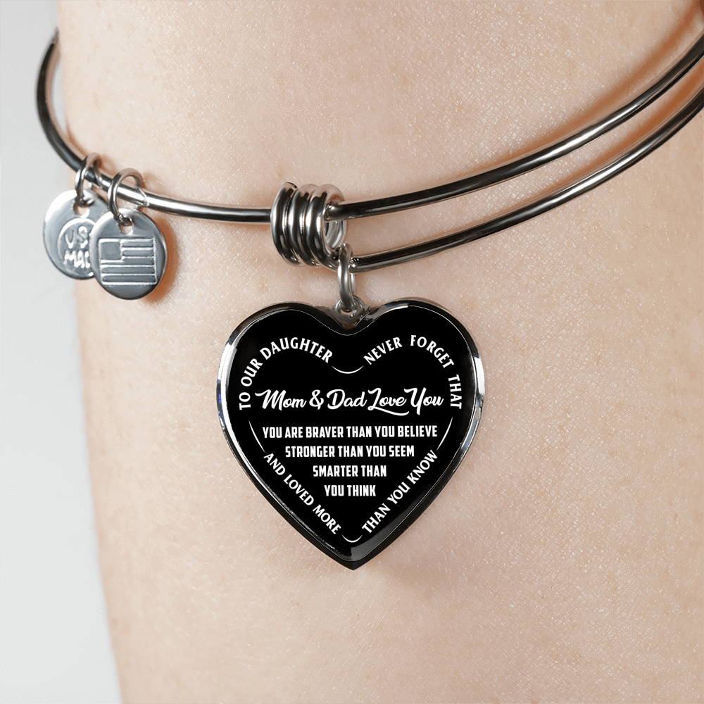 TO OUR DAUGHTER, YOU ARE BRAVER, MOM & DAD LOVE YOU - GOLD AND SILVER FINISHED HEART SHAPED BANGLE BRACELET (WHITE TEXT ON BLACK)