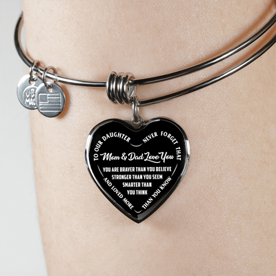 TO OUR DAUGHTER, YOU ARE BRAVER, MOM & DAD LOVE YOU - GOLD AND SILVER FINISHED HEART SHAPED BANGLE BRACELET (WHITE TEXT ON BLACK)
