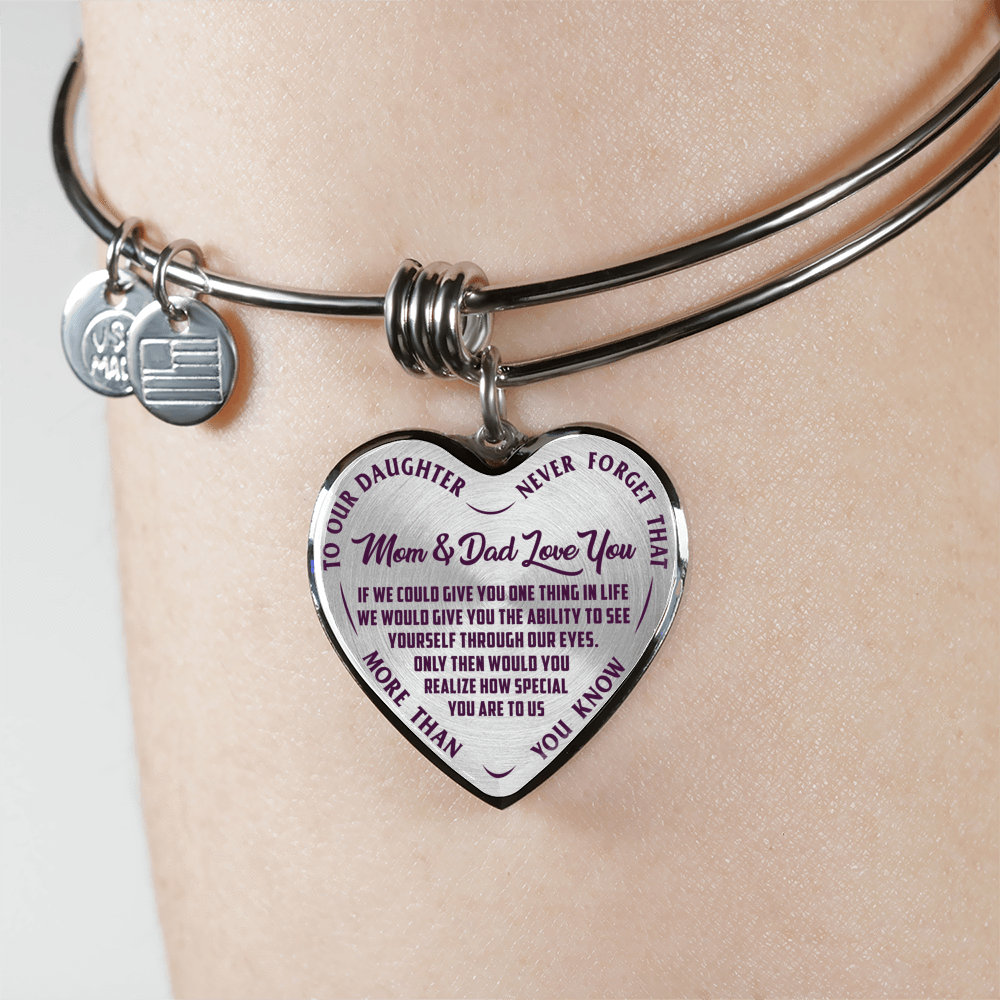 TO OUR DAUGHTER, MOM & DAD LOVE YOU, NEVER FORGET THAT - GOLD AND SILVER FINISHED HEART SHAPED BANGLE BRACELET (PURPLE TEXT ON TRANSPARENT)