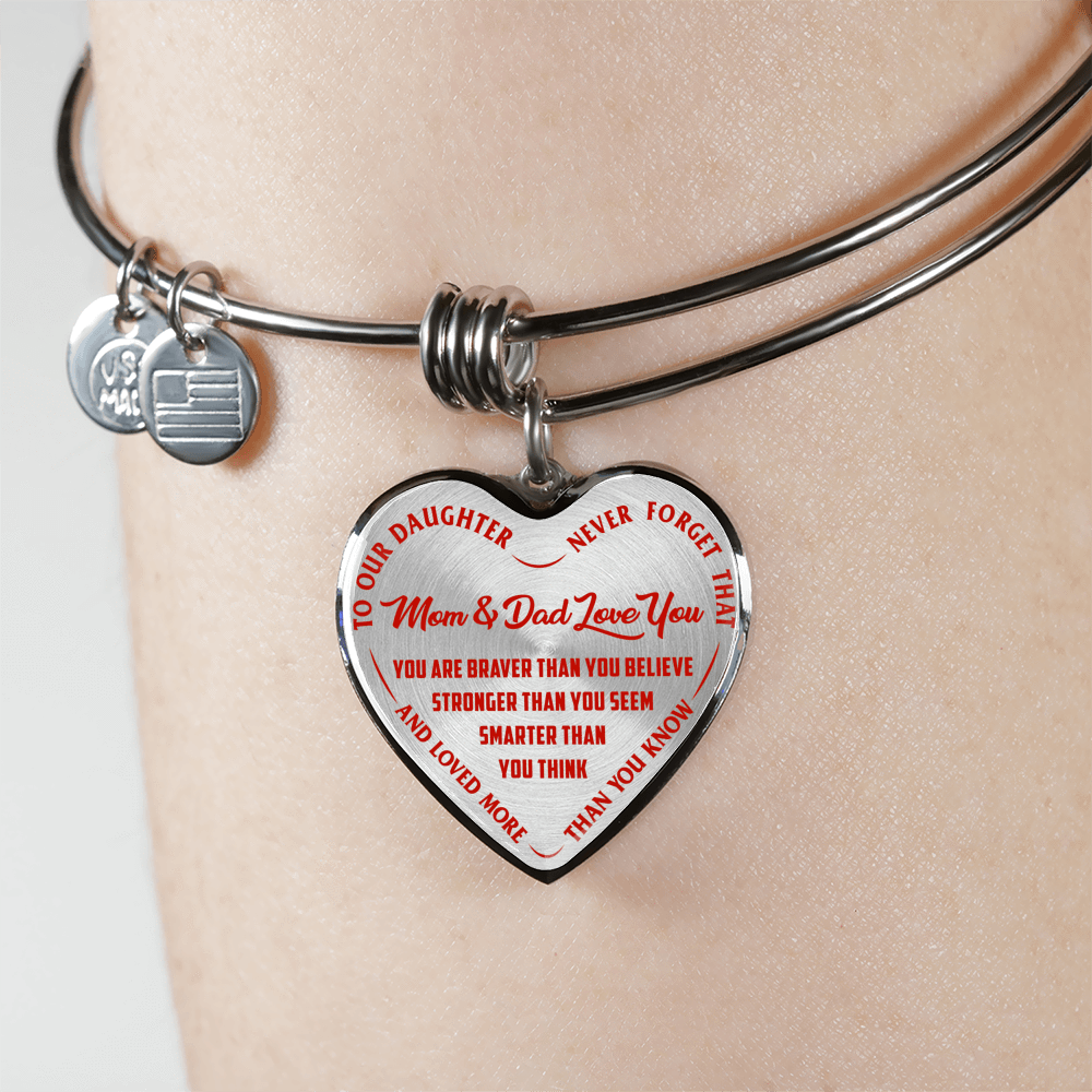 TO OUR DAUGHTER, YOU ARE BRAVER, MOM & DAD LOVE YOU - GOLD AND SILVER FINISHED HEART SHAPED BANGLE BRACELET (RED TEXT ON TRANSPARENT)