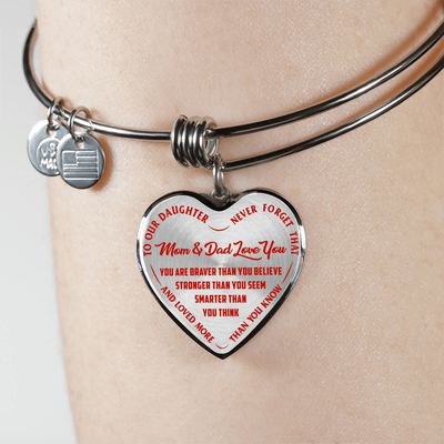 TO OUR DAUGHTER, YOU ARE BRAVER, MOM & DAD LOVE YOU - GOLD AND SILVER FINISHED HEART SHAPED BANGLE BRACELET (RED TEXT ON TRANSPARENT)