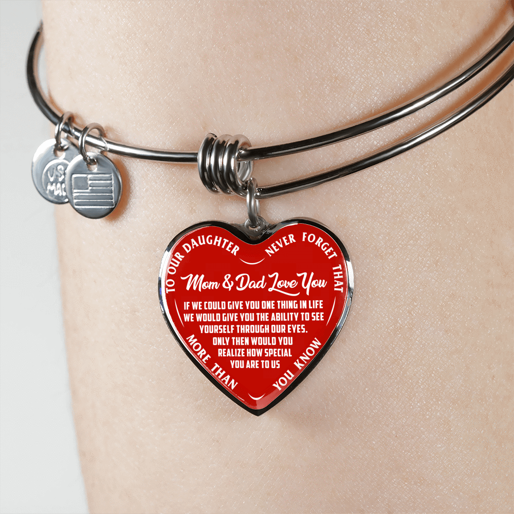 TO OUR DAUGHTER, MOM & DAD LOVE YOU, NEVER FORGET THAT - GOLD AND SILVER FINISHED HEART SHAPED BANGLE BRACELET (WHITE TEXT ON RED)