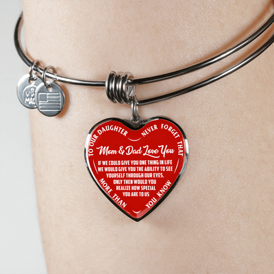 TO OUR DAUGHTER, MOM & DAD LOVE YOU, NEVER FORGET THAT - GOLD AND SILVER FINISHED HEART SHAPED BANGLE BRACELET (WHITE TEXT ON RED)