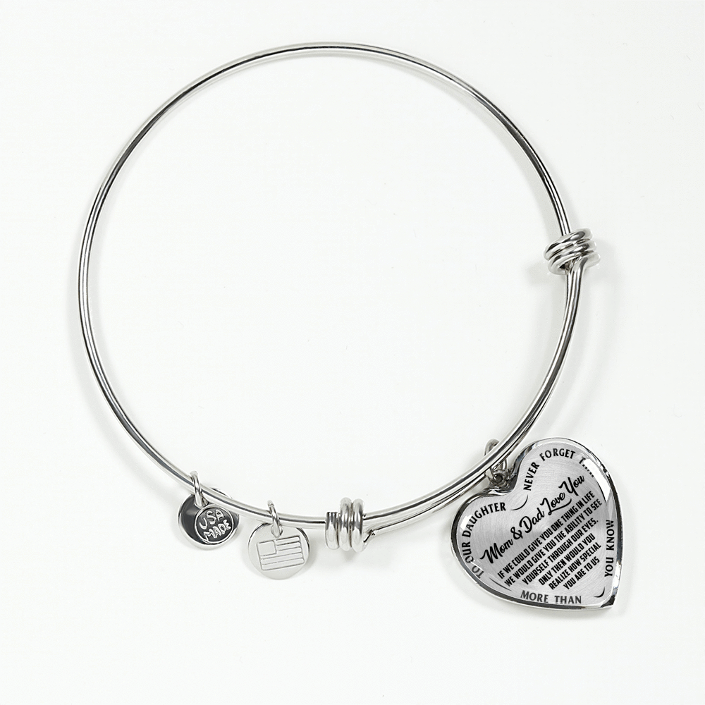 TO OUR DAUGHTER, MOM & DAD LOVE YOU, NEVER FORGET THAT - GOLD AND SILVER FINISHED HEART SHAPED BANGLE BRACELET (BLACK TEXT ON TRANSPARENT)