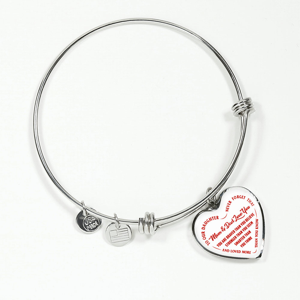 TO OUR DAUGHTER, YOU ARE BRAVER, MOM & DAD LOVE YOU - GOLD AND SILVER FINISHED HEART SHAPED BANGLE BRACELET (RED TEXT ON WHITE)