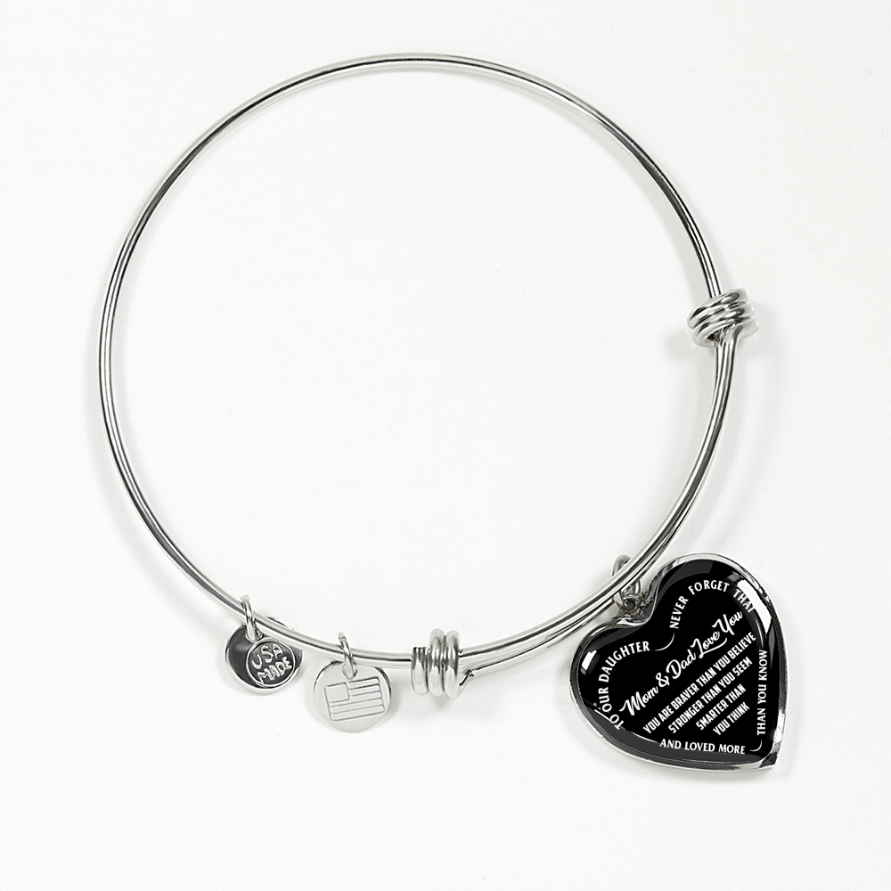 TO OUR DAUGHTER, YOU ARE BRAVER, MOM & DAD LOVE YOU - GOLD AND SILVER FINISHED HEART SHAPED BANGLE BRACELET (WHITE TEXT ON BLACK)