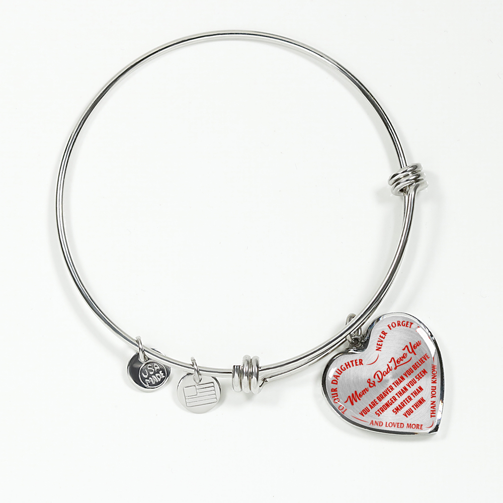 TO OUR DAUGHTER, YOU ARE BRAVER, MOM & DAD LOVE YOU - GOLD AND SILVER FINISHED HEART SHAPED BANGLE BRACELET (RED TEXT ON TRANSPARENT)