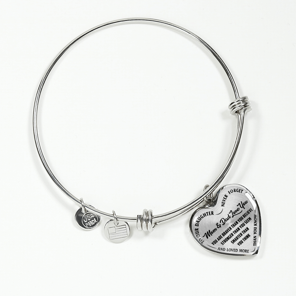 TO OUR DAUGHTER, YOU ARE BRAVER, MOM & DAD LOVE YOU - GOLD AND SILVER FINISHED HEART SHAPED BANGLE BRACELET (BLACK TEXT ON TRANSPARENT)