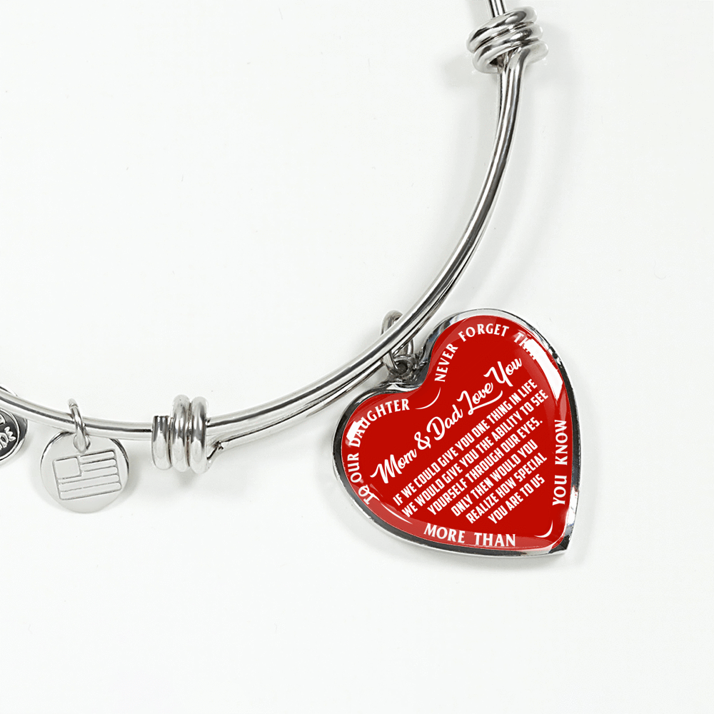 TO OUR DAUGHTER, MOM & DAD LOVE YOU, NEVER FORGET THAT - GOLD AND SILVER FINISHED HEART SHAPED BANGLE BRACELET (WHITE TEXT ON RED)