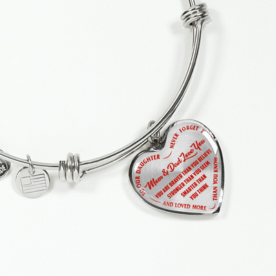 TO OUR DAUGHTER, YOU ARE BRAVER, MOM & DAD LOVE YOU - GOLD AND SILVER FINISHED HEART SHAPED BANGLE BRACELET (RED TEXT ON TRANSPARENT)