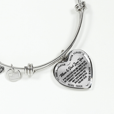 TO OUR DAUGHTER, MOM & DAD LOVE YOU, NEVER FORGET THAT - GOLD AND SILVER FINISHED HEART SHAPED BANGLE BRACELET (BLACK TEXT ON TRANSPARENT)