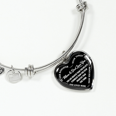 TO OUR DAUGHTER, YOU ARE BRAVER, MOM & DAD LOVE YOU - GOLD AND SILVER FINISHED HEART SHAPED BANGLE BRACELET (WHITE TEXT ON BLACK)