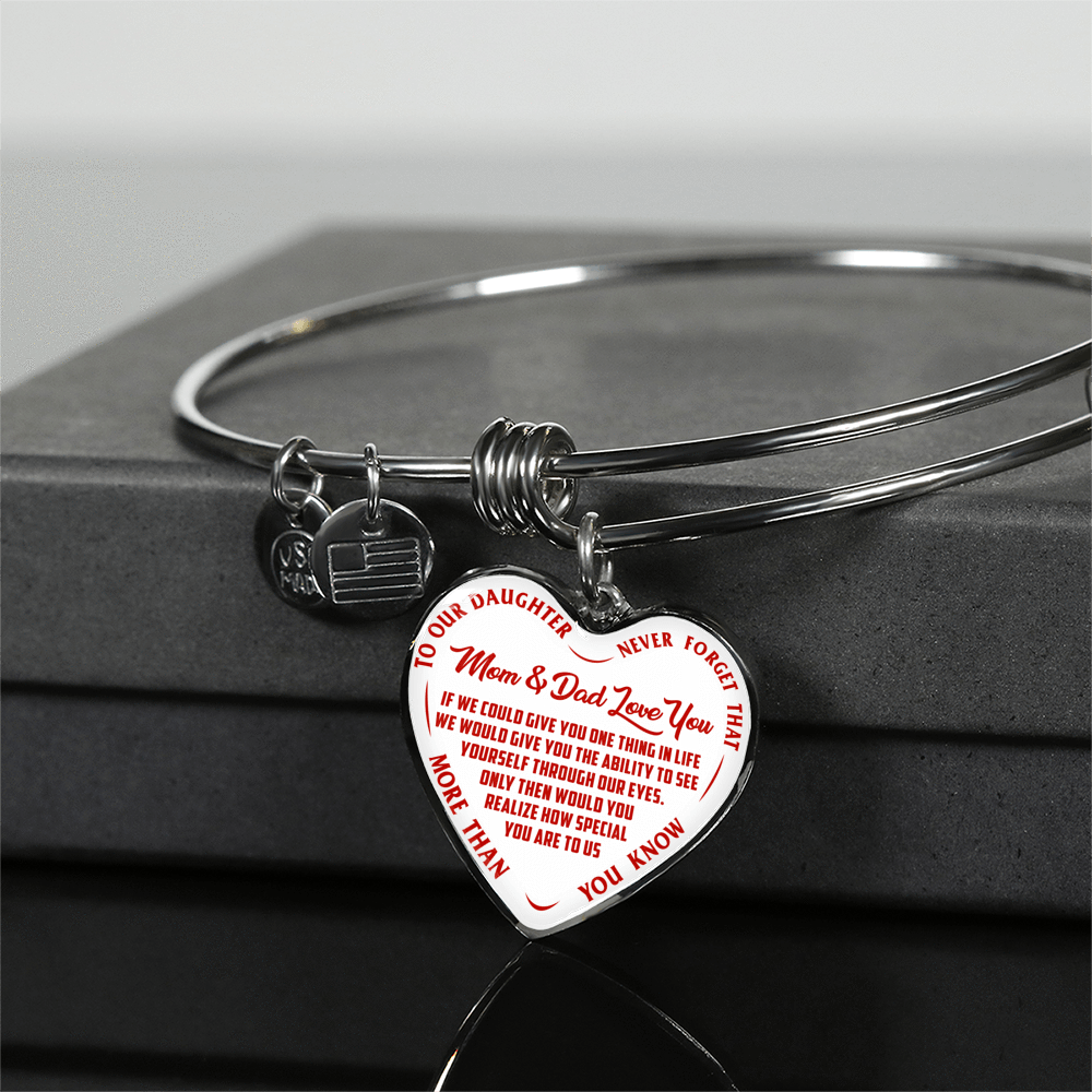 TO OUR DAUGHTER, MOM & DAD LOVE YOU, NEVER FORGET THAT - GOLD AND SILVER FINISHED HEART SHAPED BANGLE BRACELET (RED TEXT ON WHITE)