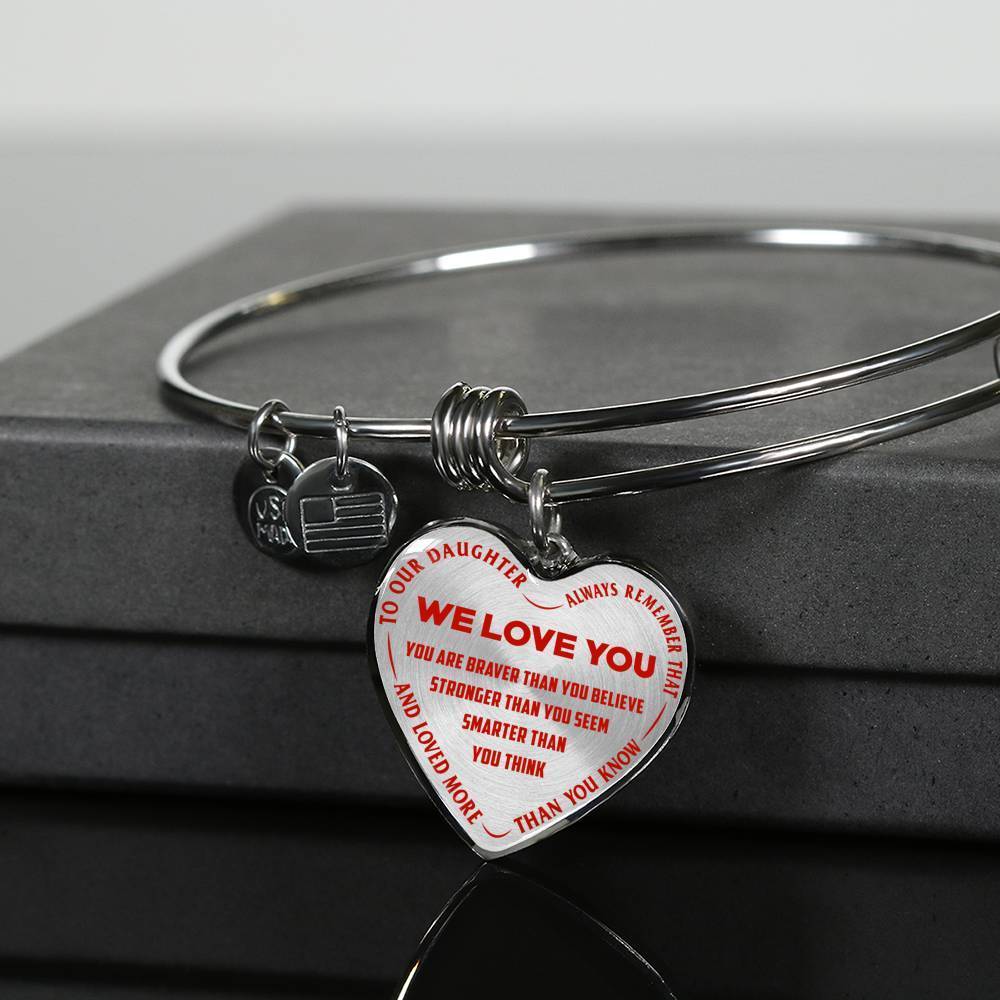 TO OUR DAUGHTER, ALWAYS REMEMBER THAT, WE LOVE YOU - (RED ON TRANSPARENT) SILVER OR GOLD FINISHED HEART SHAPED BANGLE BRACELET NEW