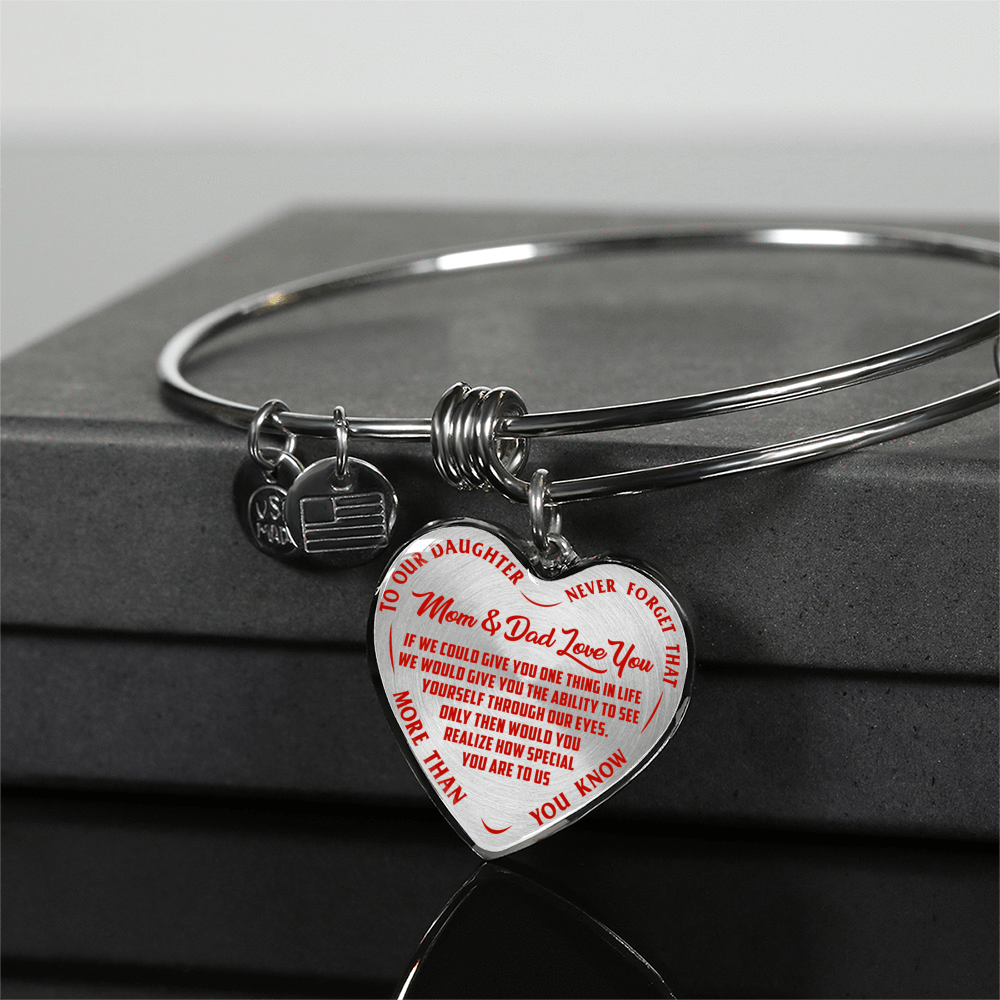 TO OUR DAUGHTER, MOM & DAD LOVE YOU, NEVER FORGET THAT - GOLD AND SILVER FINISHED HEART SHAPED BANGLE BRACELET (RED TEXT ON TRANSPARENT)