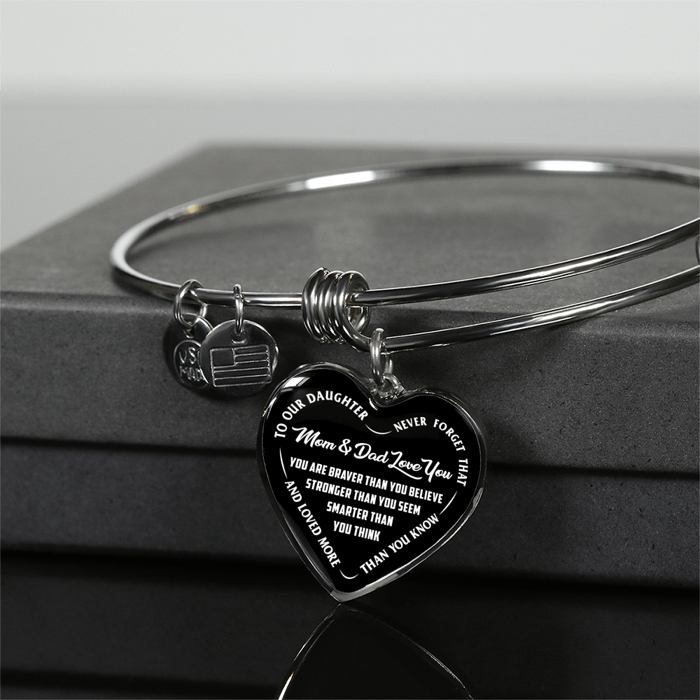 TO OUR DAUGHTER, YOU ARE BRAVER, MOM & DAD LOVE YOU - GOLD AND SILVER FINISHED HEART SHAPED BANGLE BRACELET (WHITE TEXT ON BLACK)