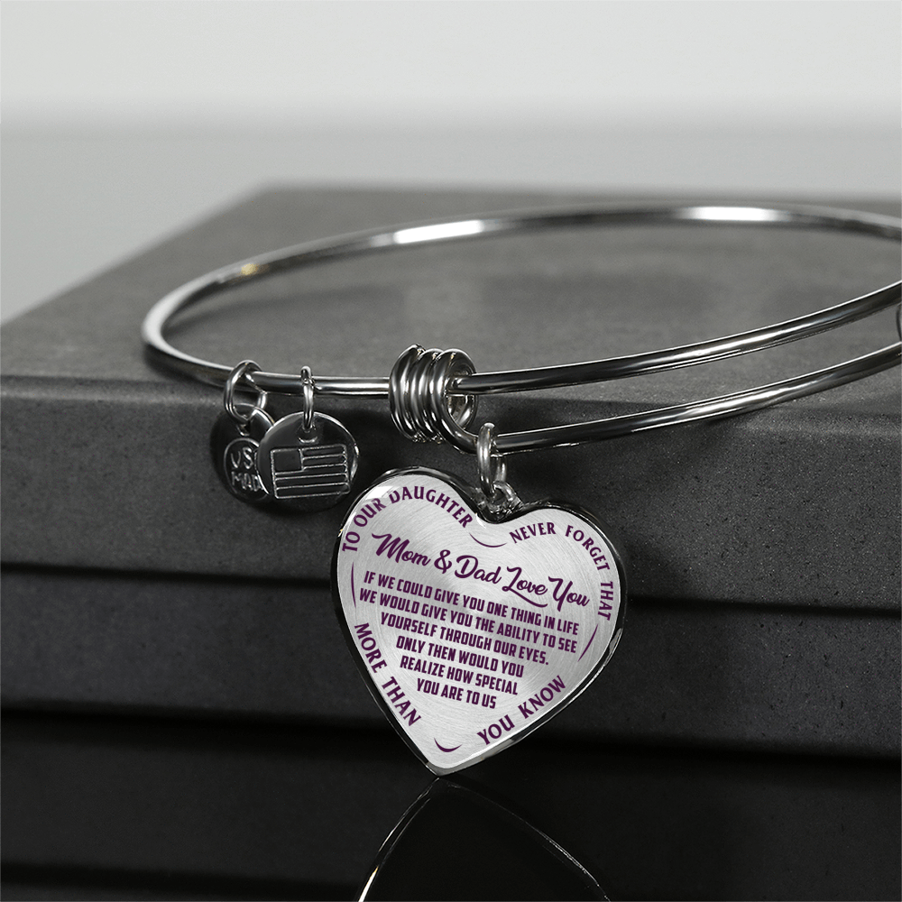 TO OUR DAUGHTER, MOM & DAD LOVE YOU, NEVER FORGET THAT - GOLD AND SILVER FINISHED HEART SHAPED BANGLE BRACELET (PURPLE TEXT ON TRANSPARENT)