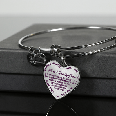 TO OUR DAUGHTER, MOM & DAD LOVE YOU, NEVER FORGET THAT - GOLD AND SILVER FINISHED HEART SHAPED BANGLE BRACELET (PURPLE TEXT ON TRANSPARENT)