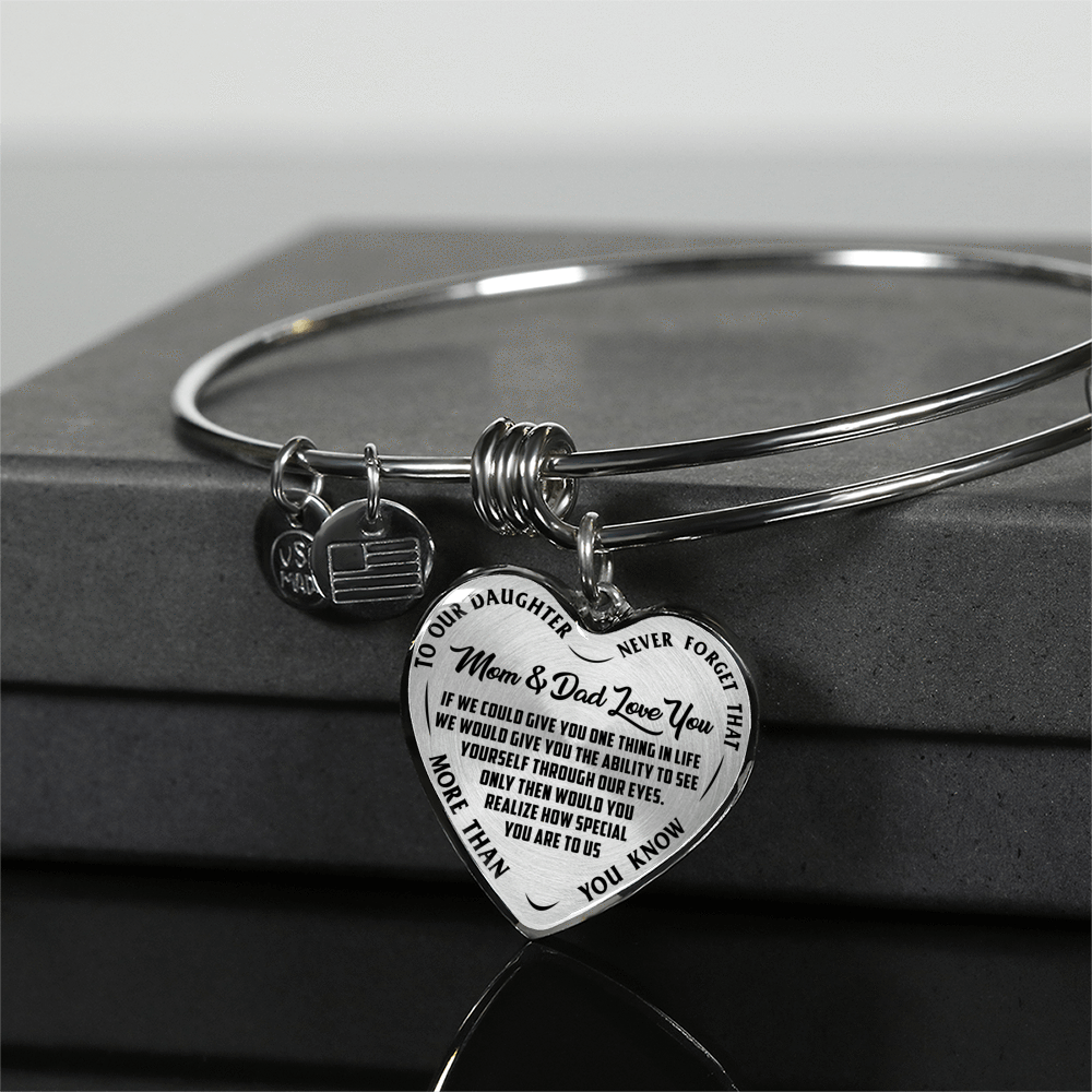 TO OUR DAUGHTER, MOM & DAD LOVE YOU, NEVER FORGET THAT - GOLD AND SILVER FINISHED HEART SHAPED BANGLE BRACELET (BLACK TEXT ON TRANSPARENT)