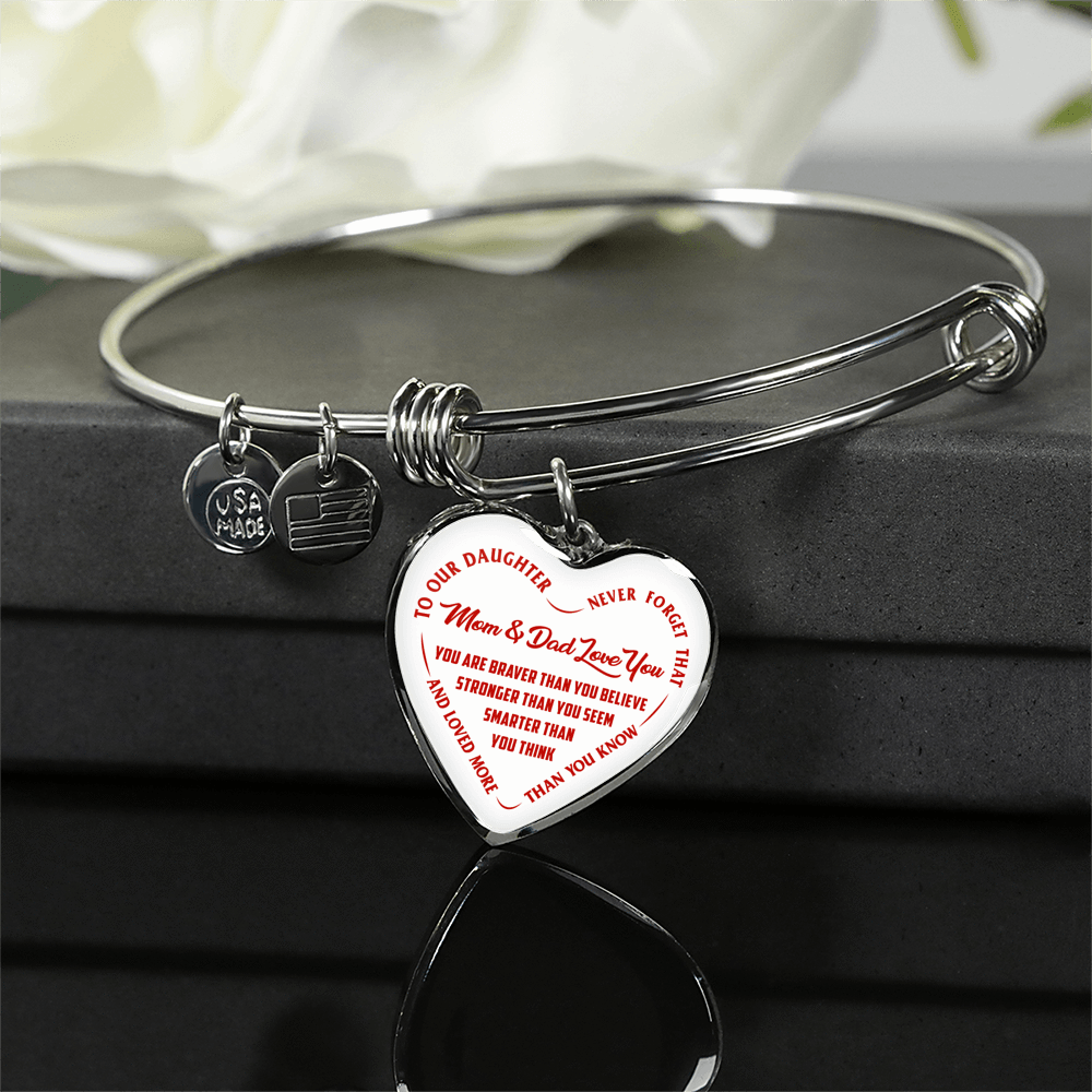 TO OUR DAUGHTER, YOU ARE BRAVER, MOM & DAD LOVE YOU - GOLD AND SILVER FINISHED HEART SHAPED BANGLE BRACELET (RED TEXT ON WHITE)