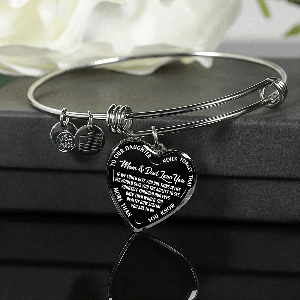 TO OUR DAUGHTER, MOM & DAD LOVE YOU, NEVER FORGET THAT - GOLD AND SILVER FINISHED HEART SHAPED BANGLE BRACELET (WHITE TEXT ON BLACK)