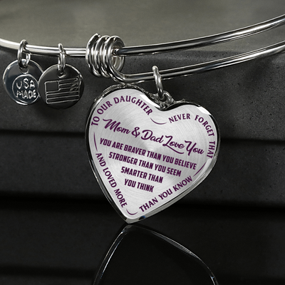 TO OUR DAUGHTER, YOU ARE BRAVER, MOM & DAD LOVE YOU - GOLD AND SILVER FINISHED HEART SHAPED NECKLACE AND BANGLE BRACELET (PURPLE TEXT ON TRANSPARENT) EO