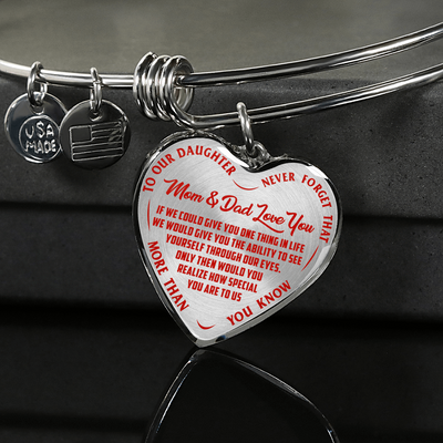 TO OUR DAUGHTER, MOM & DAD LOVE YOU, NEVER FORGET THAT - GOLD AND SILVER FINISHED HEART SHAPED BANGLE BRACELET (RED TEXT ON TRANSPARENT)