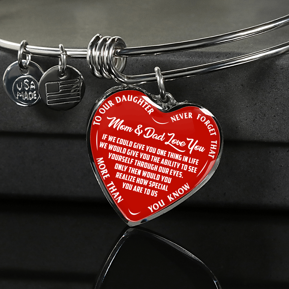 TO OUR DAUGHTER, MOM & DAD LOVE YOU, NEVER FORGET THAT - GOLD AND SILVER FINISHED HEART SHAPED BANGLE BRACELET (WHITE TEXT ON RED)