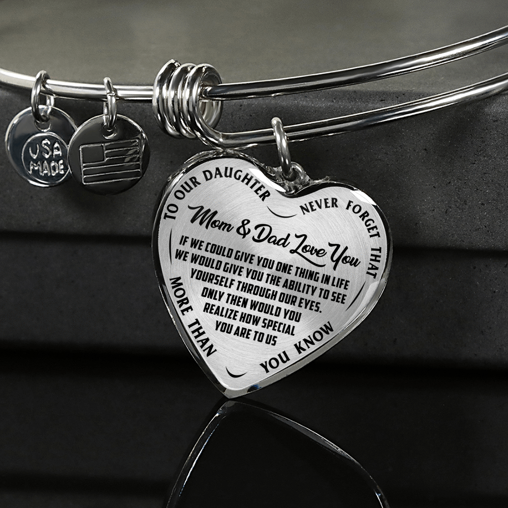 TO OUR DAUGHTER, MOM & DAD LOVE YOU, NEVER FORGET THAT - GOLD AND SILVER FINISHED HEART SHAPED BANGLE BRACELET (BLACK TEXT ON TRANSPARENT)